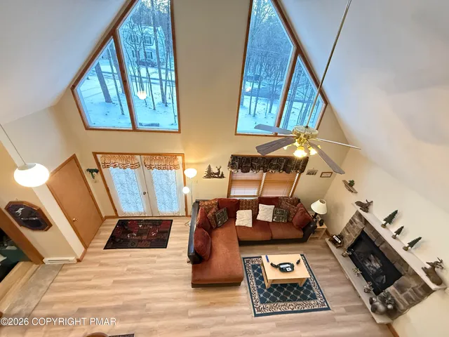 a living room with lots of furniture and kitchen view