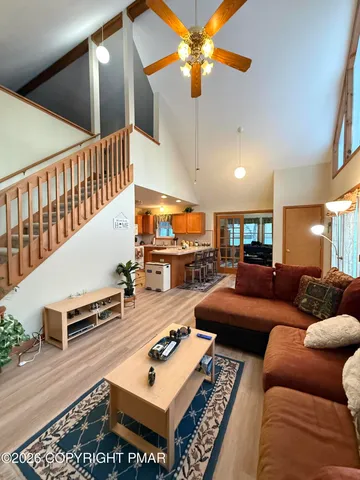 a living room with furniture and a floor to ceiling window