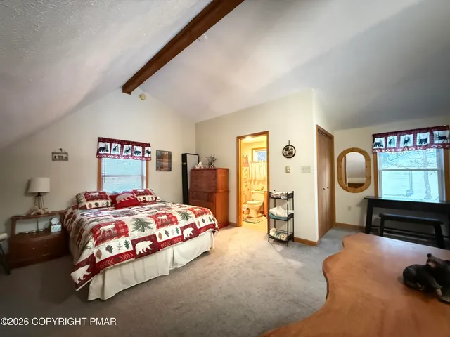 a bedroom with a bed a dresser and dresser