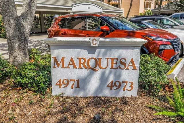 a view of a hallway with potted plants