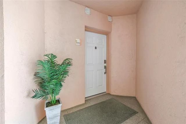 a kitchen with stainless steel appliances granite countertop a stove top oven a sink dishwasher a refrigerator and white cabinets with wooden floor