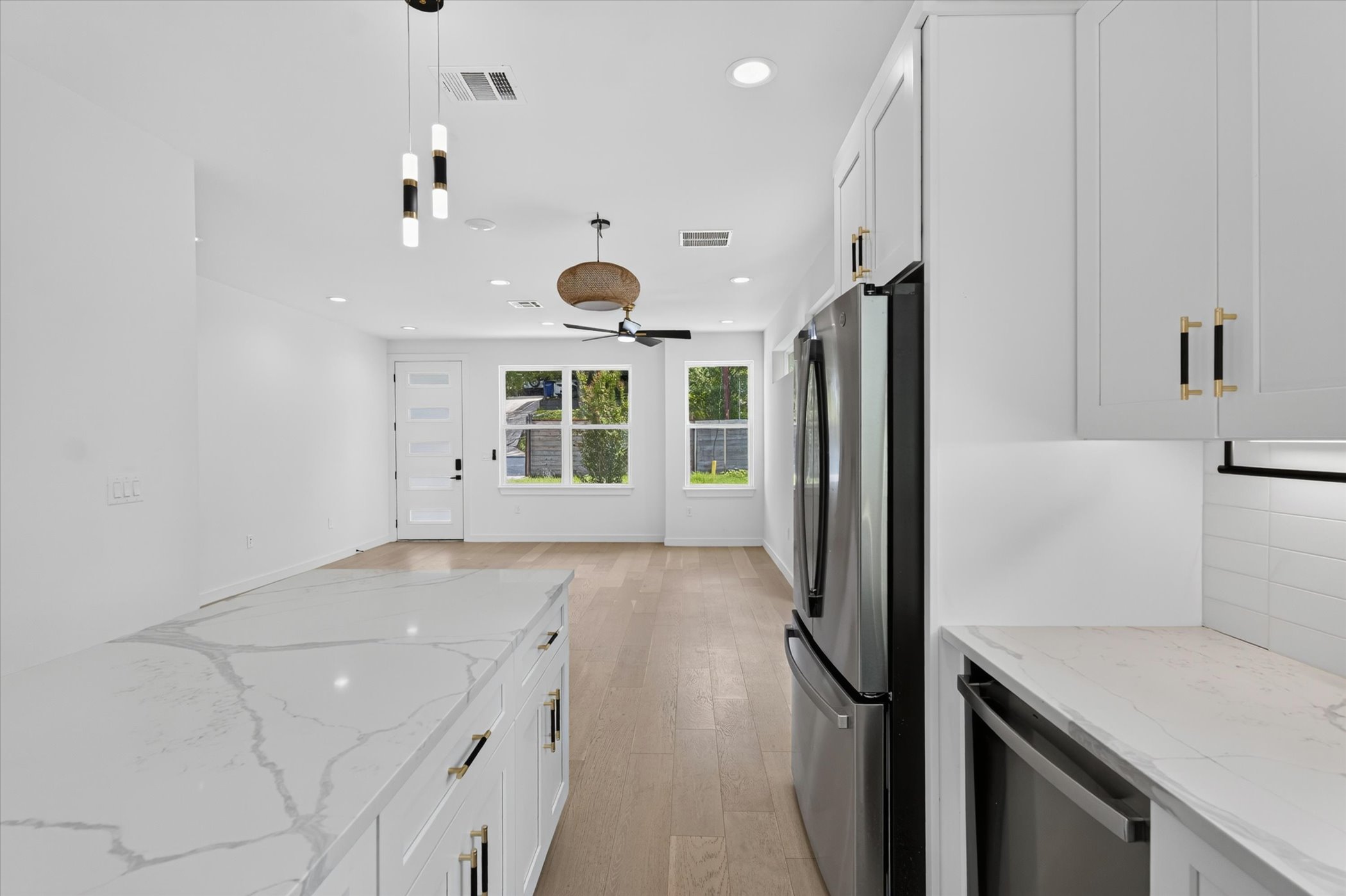 5305 Ledesma Road, Unit 1 Austin, TX 78721 - Photo 14 of 37 Gleaming stone countertops and a modern open layout seamlessly connect the kitchen and living areas.