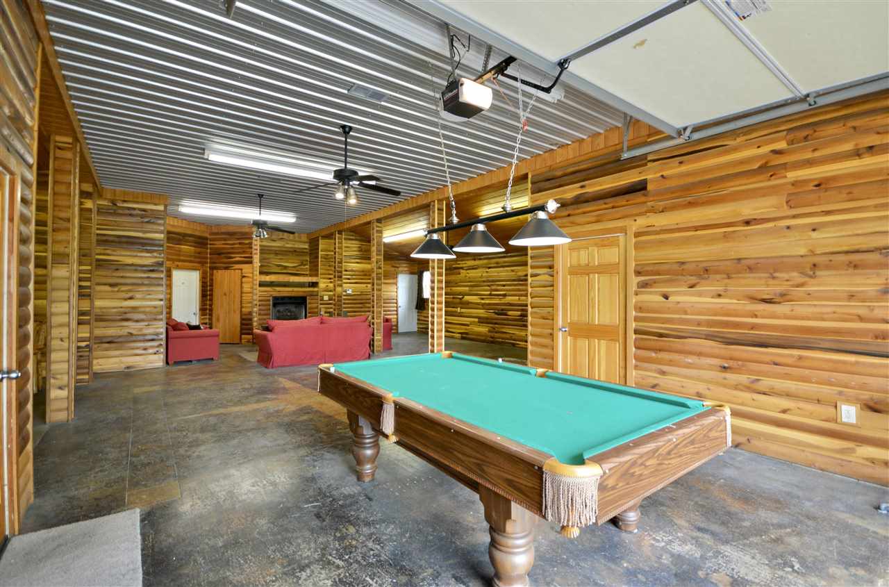 315 Hill House Road Toone, TN 38381 - Photo 21 of 23 a view of a backyard with chairs and a garage