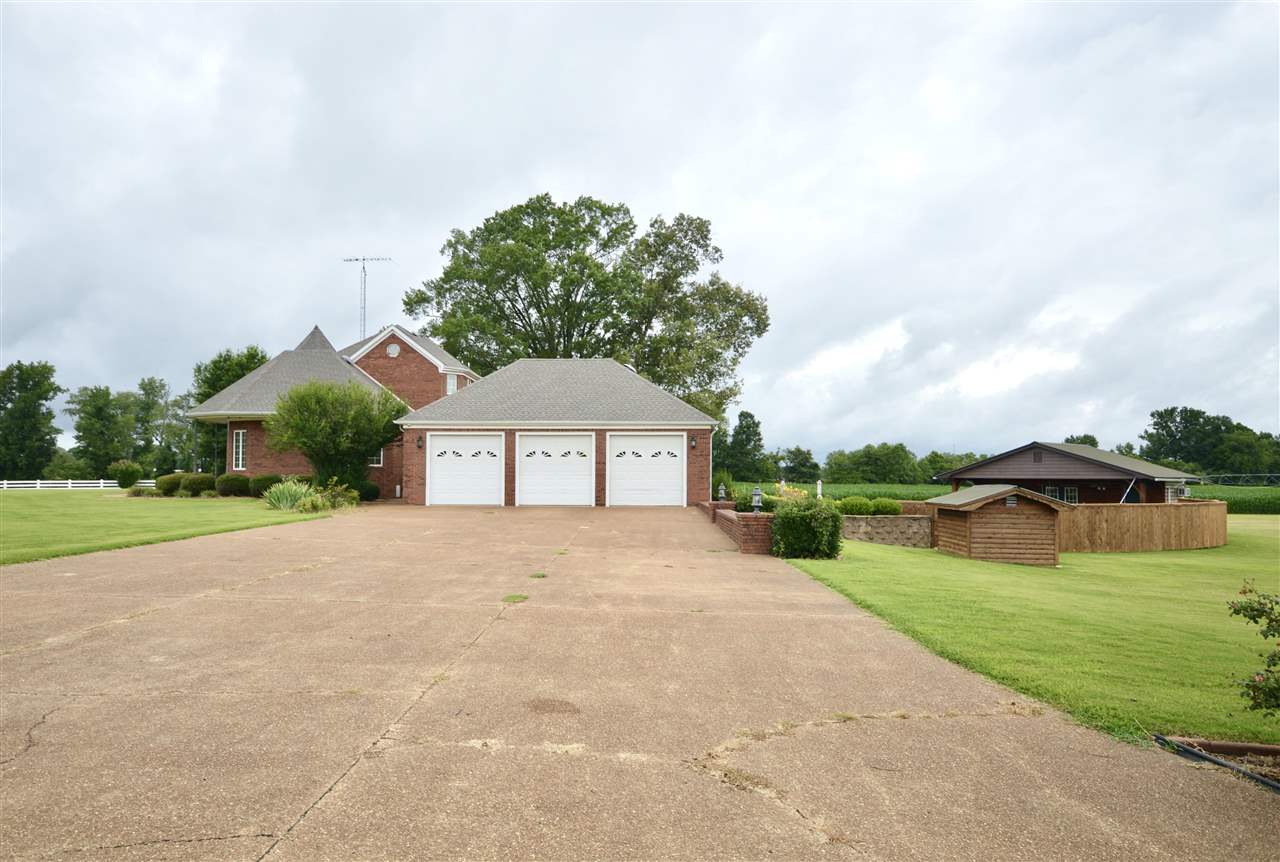 315 Hill House Road Toone, TN 38381 - Photo 23 of 23 a front view of a house with a yard and garage