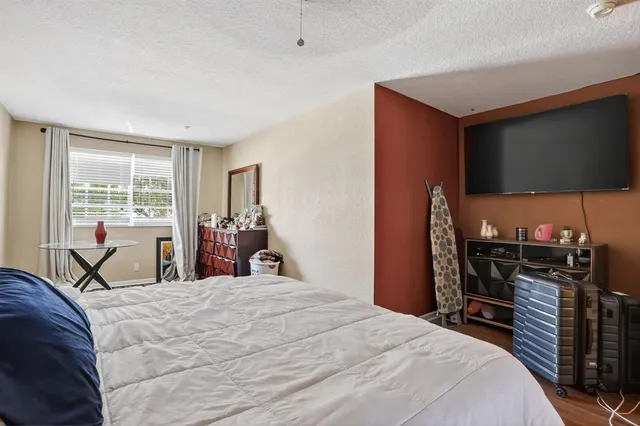 a bed room with a bed and a television