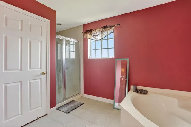 a bathroom with a bathtub and shower