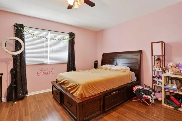 a bedroom with a bed and wooden floor