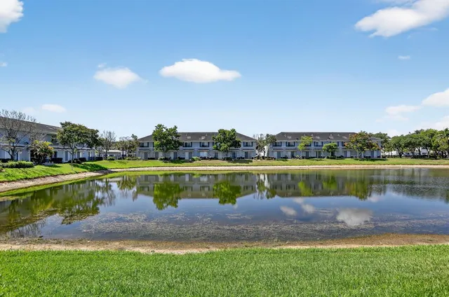 a view of swimming pool with a yard and lake view