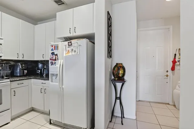a white refrigerator freezer sitting in a kitchen