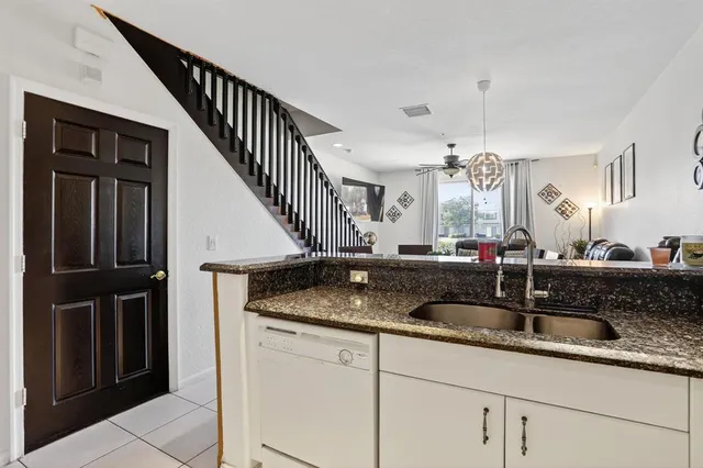 a kitchen with sink and mirror