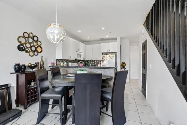 a view of a dining room with furniture and kitchen view