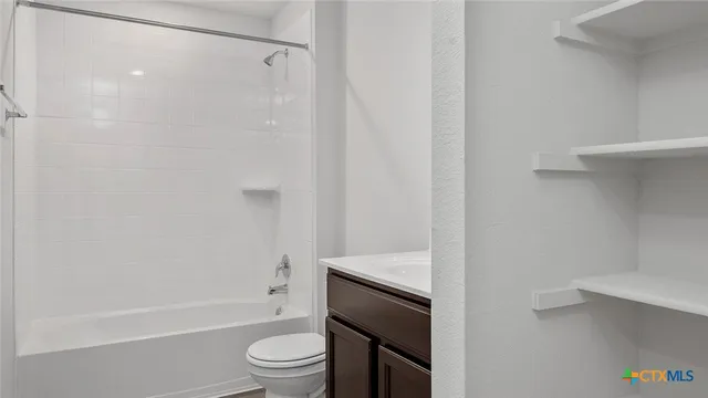 a bathroom with a shower a toilet and a sink