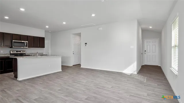 a view of kitchen with microwave and cabinets