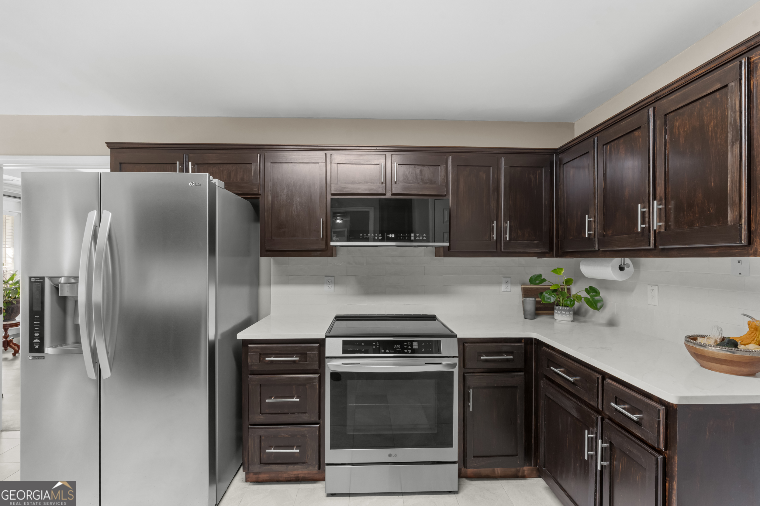 357 Pound Road Guyton, GA 31312 - Photo 15 of 49 a kitchen with a sink and stainless steel appliances