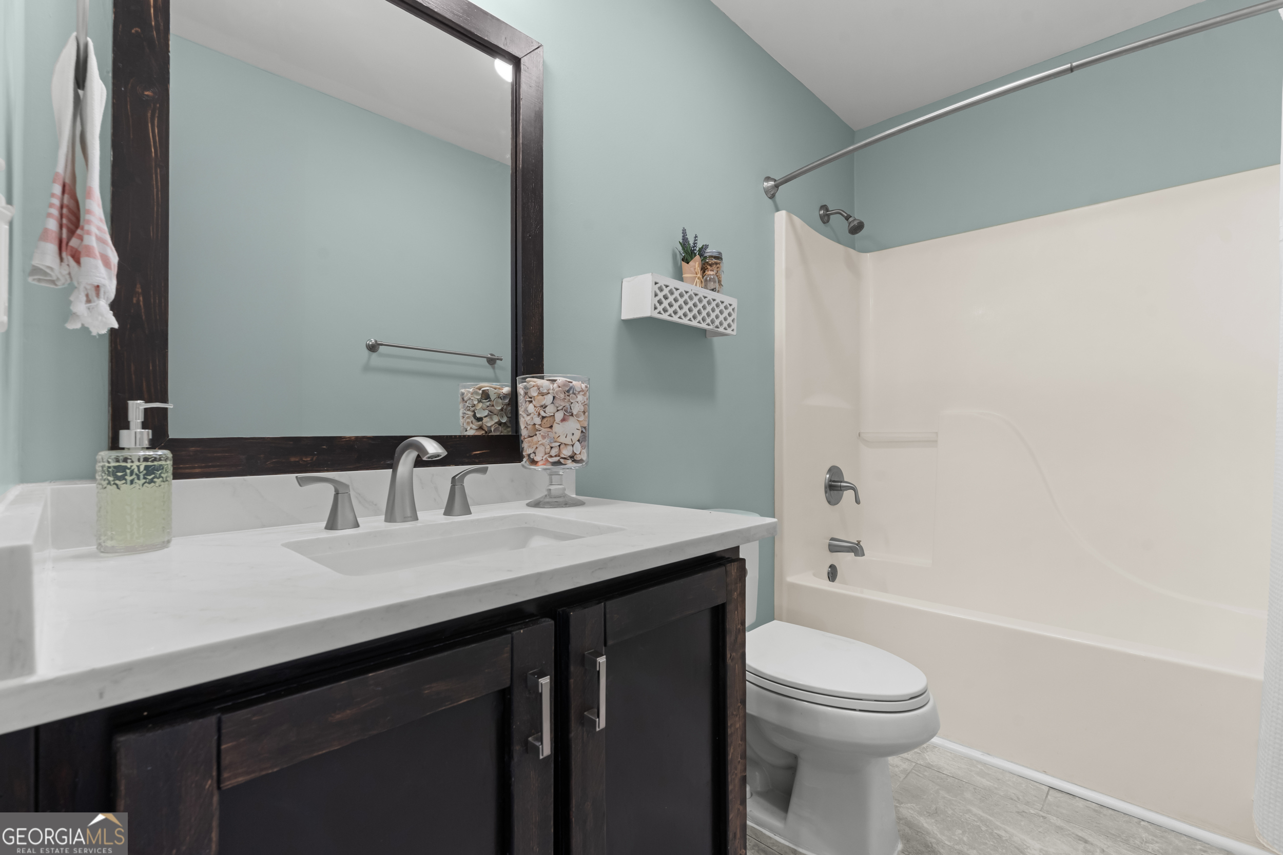 357 Pound Road Guyton, GA 31312 - Photo 23 of 49 a bathroom with a sink a toilet a mirror and shower