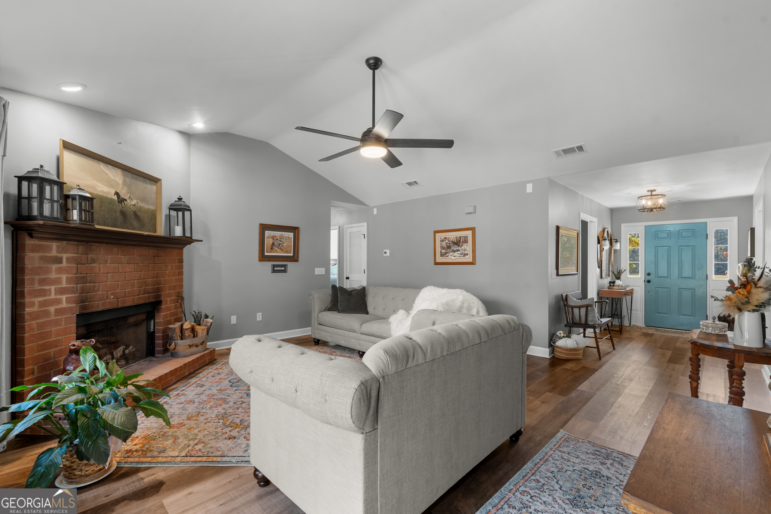 357 Pound Road Guyton, GA 31312 - Photo 8 of 49 a living room with furniture a fireplace and a ceiling fan