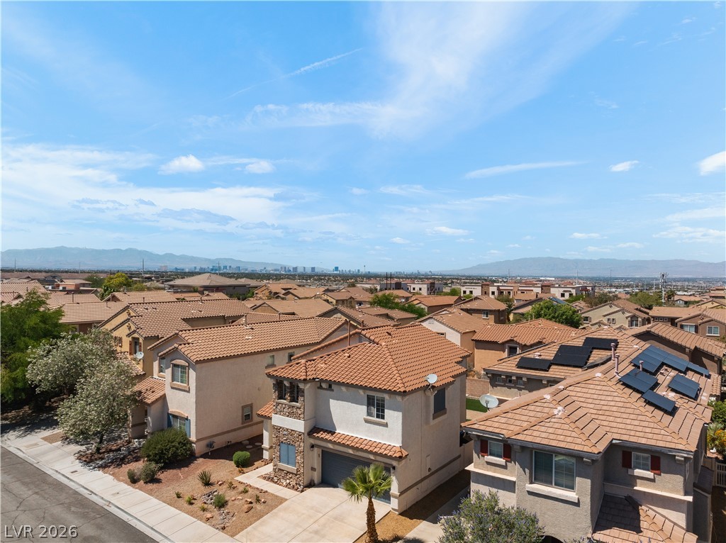 1328 Spice Ridge Court Henderson, NV 89012 - Photo 47 of 51 An aerial view captures a vibrant neighborhood under a clear sky, showcasing a well-maintained community.