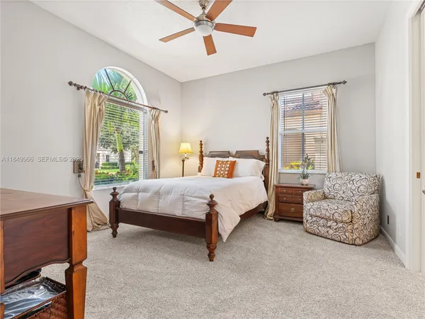 a bed sitting in a bedroom next to a window