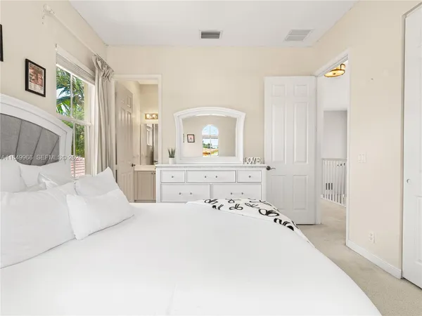 a bedroom with a bed and a mirror