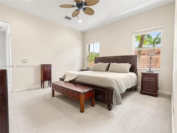 a bedroom with a bed dresser and a window