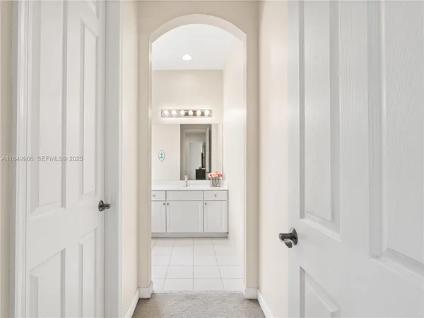 a bathroom with a granite countertop sink a mirror and vanity