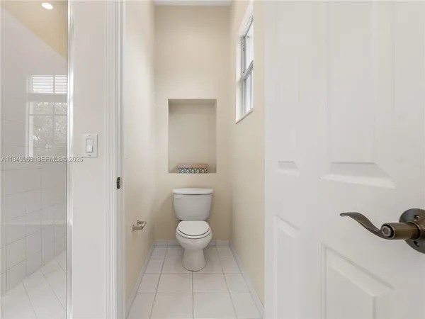 a bathroom with a sink a toilet and a window