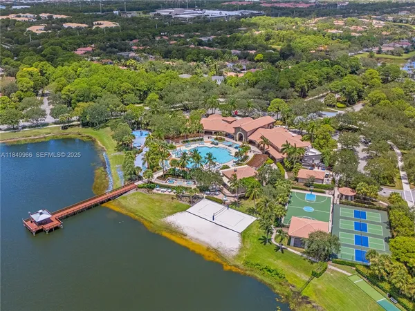 an aerial view of residential houses with outdoor space and swimming pool