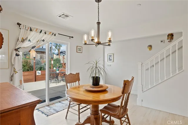 a dining room with furniture a chandelier and window