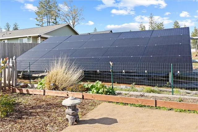 a view of a terrace with furniture and a garden