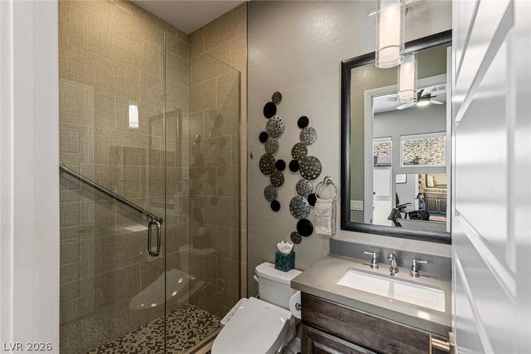 10118 Copper Edge Road Las Vegas, NV 89148 - Photo 24 of 48 A well-appointed bathroom features a glass-enclosed shower and a vanity with a contemporary sink.