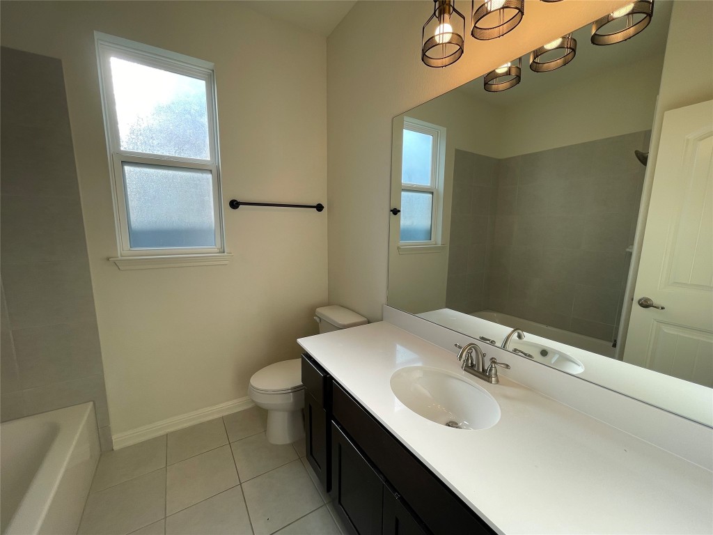 142 Simon Kyle, TX 78640 - Photo 11 of 16 a bathroom with a sink toilet and a mirror