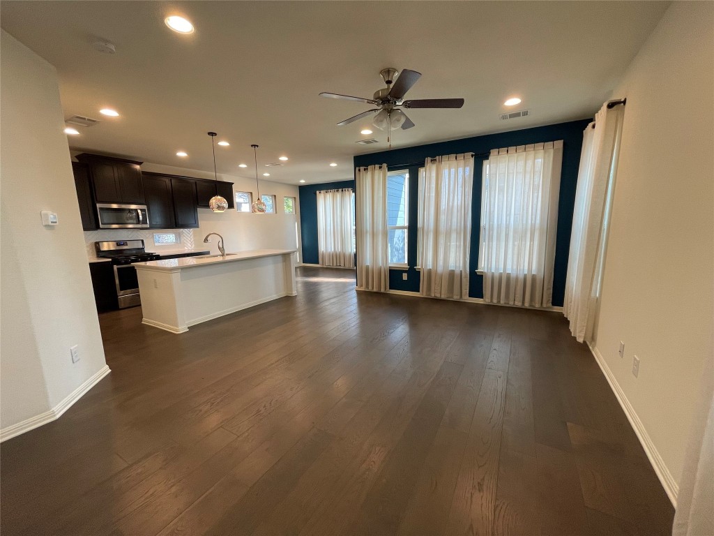 142 Simon Kyle, TX 78640 - Photo 5 of 16 a view of a kitchen with a sink and a large window
