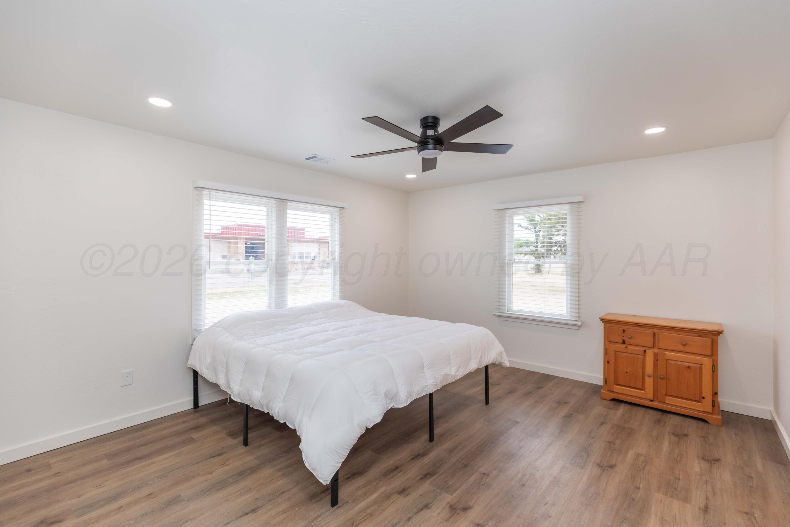 504 High Street Claude, TX 79019 - Photo 29 of 39 a bedroom with a bed and a window