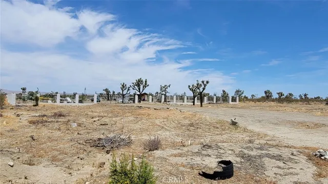 a view of a houses with snow on the road