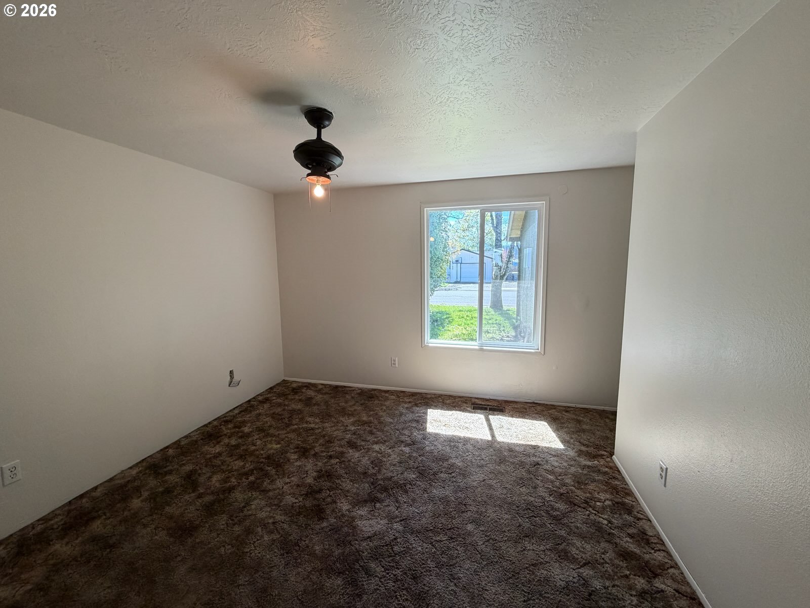 3328 Foxglove Street Lebanon, OR 97355 - Photo 11 of 16 an empty room with windows and fan