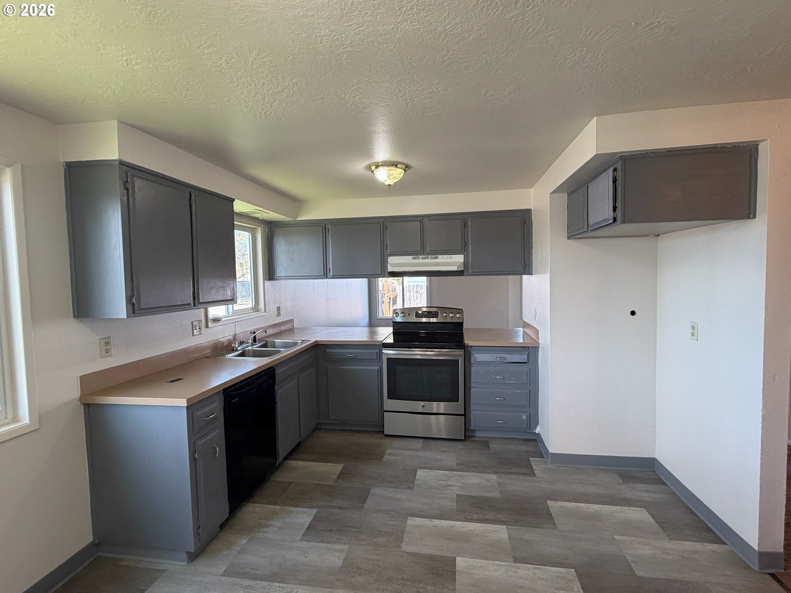 3328 Foxglove Street Lebanon, OR 97355 - Photo 2 of 16 a kitchen with stainless steel appliances granite countertop a stove top oven a sink and a refrigerator