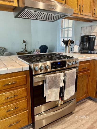 205 Chambers Street Ridgecrest, CA 93555 - Photo 11 of 32 a stove top oven sitting inside of a kitchen