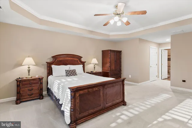 a bedroom with a bed a chandelier and a chandelier