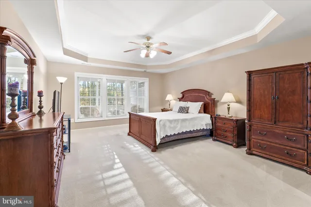 a bedroom with a large bed and a chandelier