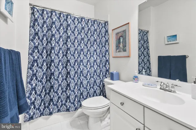 a bathroom with a sink toilet and mirror