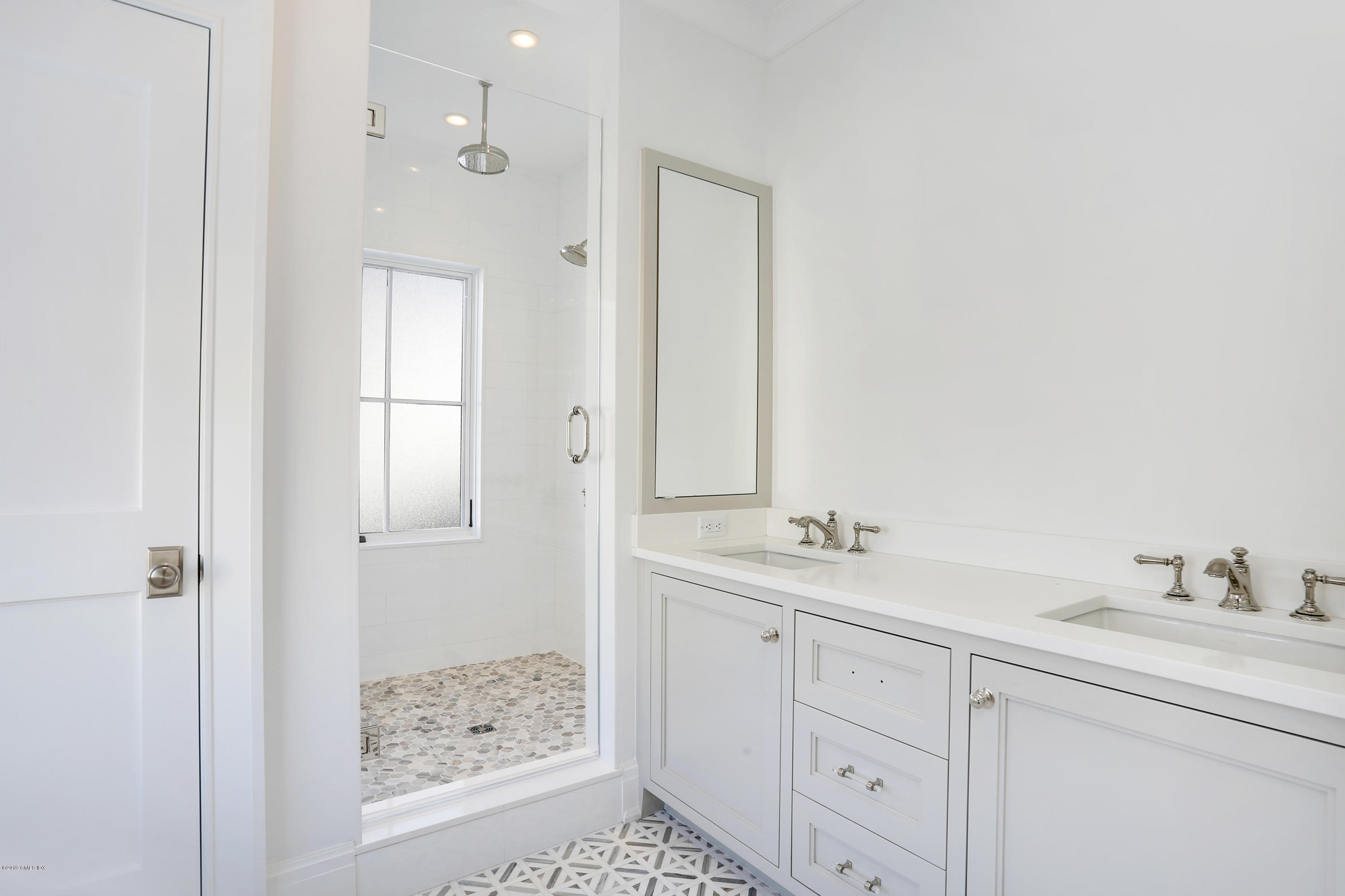 59 East Elm Street, Unit BACK Greenwich, CT 06830 - Photo 11 of 18 a bathroom with a shower sink and mirror