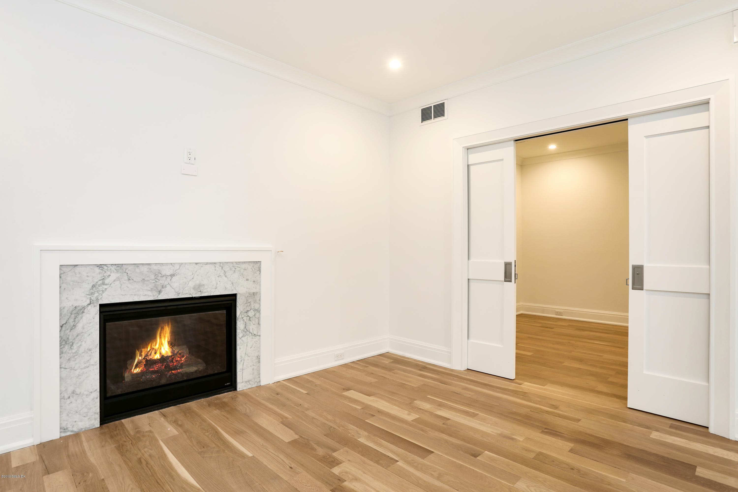 59 East Elm Street, Unit BACK Greenwich, CT 06830 - Photo 12 of 18 a view of an empty room with a fireplace