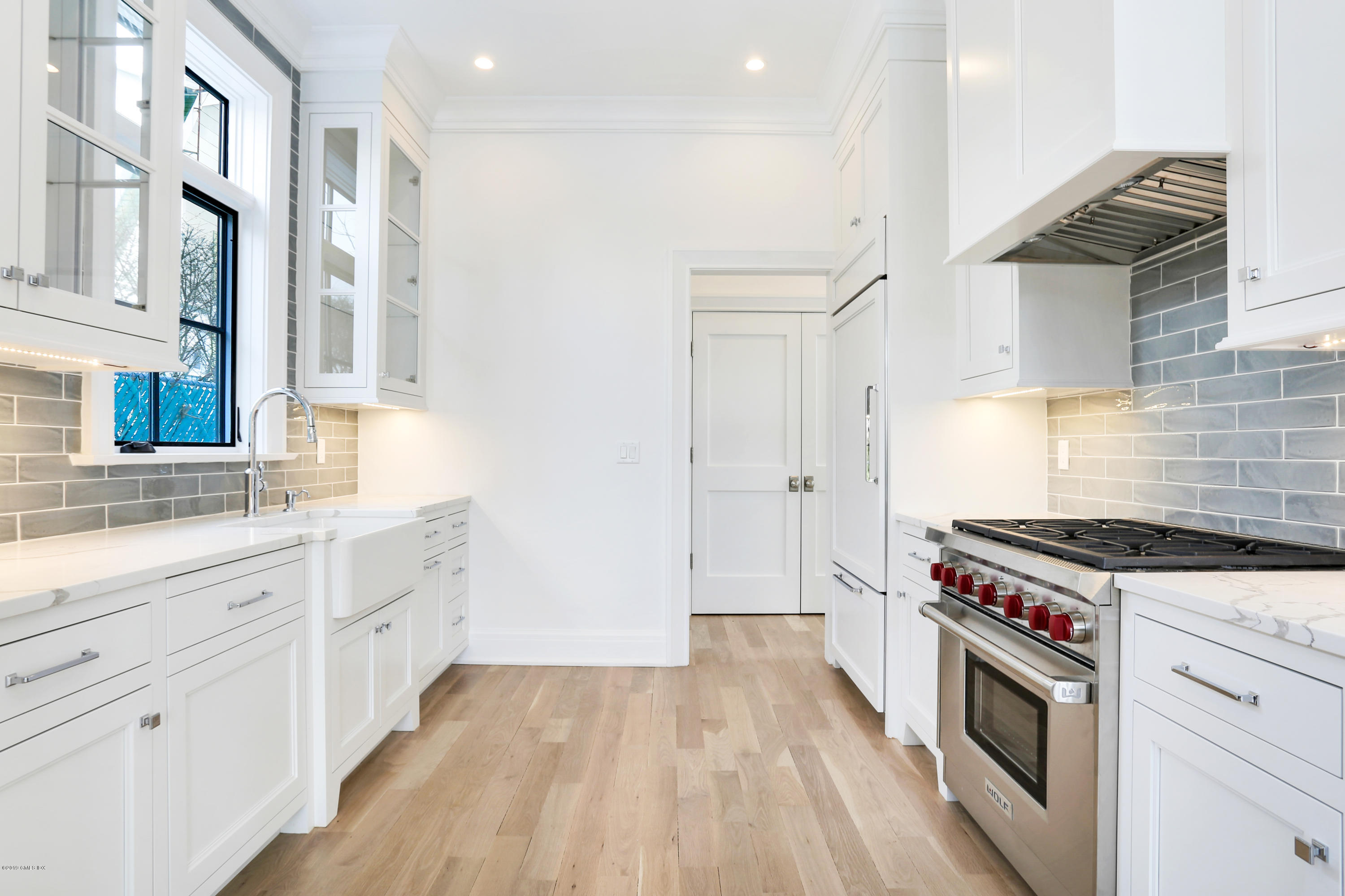 59 East Elm Street, Unit BACK Greenwich, CT 06830 - Photo 5 of 18 a kitchen with a stove top oven sink and cabinets