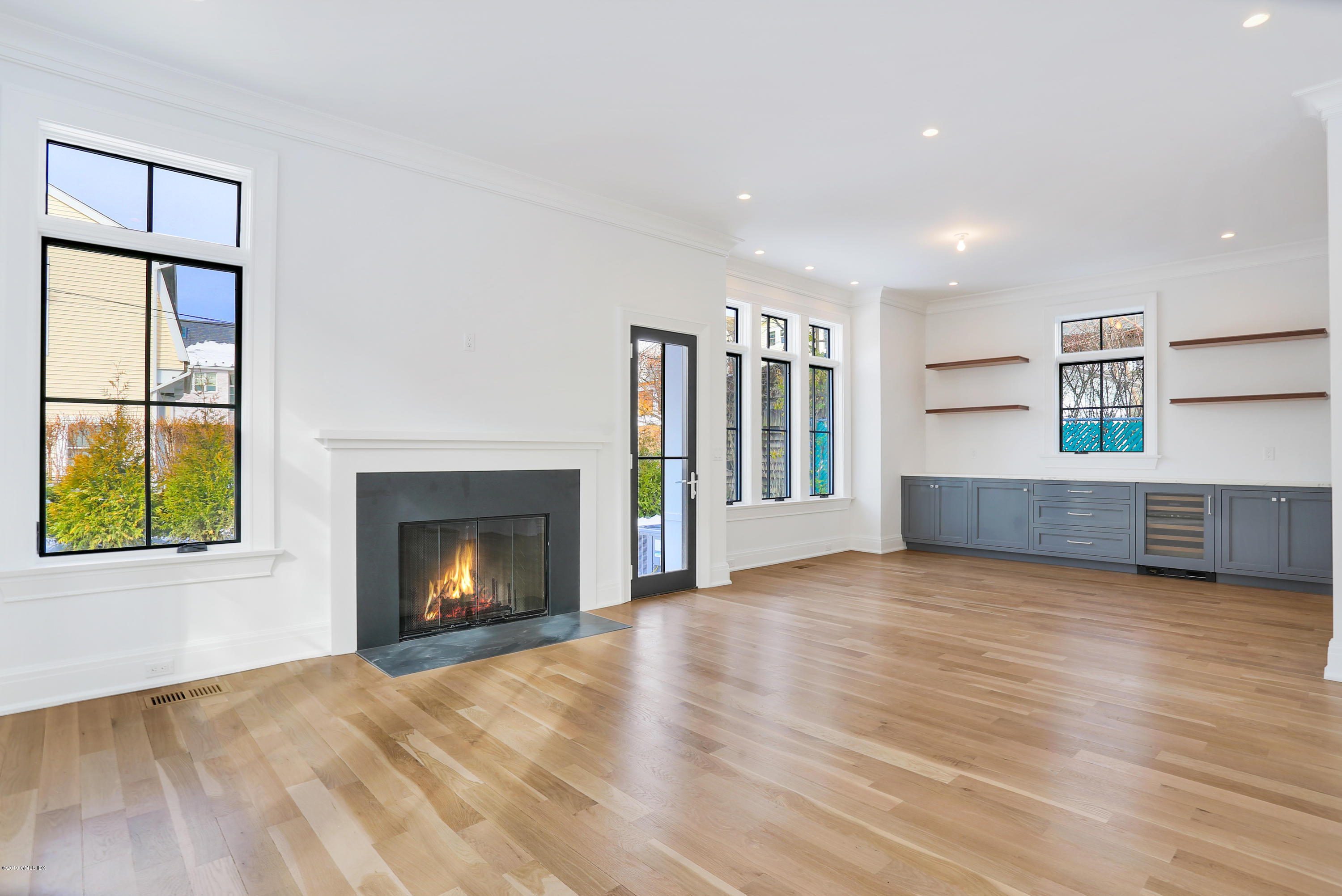 59 East Elm Street, Unit BACK Greenwich, CT 06830 - Photo 6 of 18 a view of an empty room with a window and fireplace