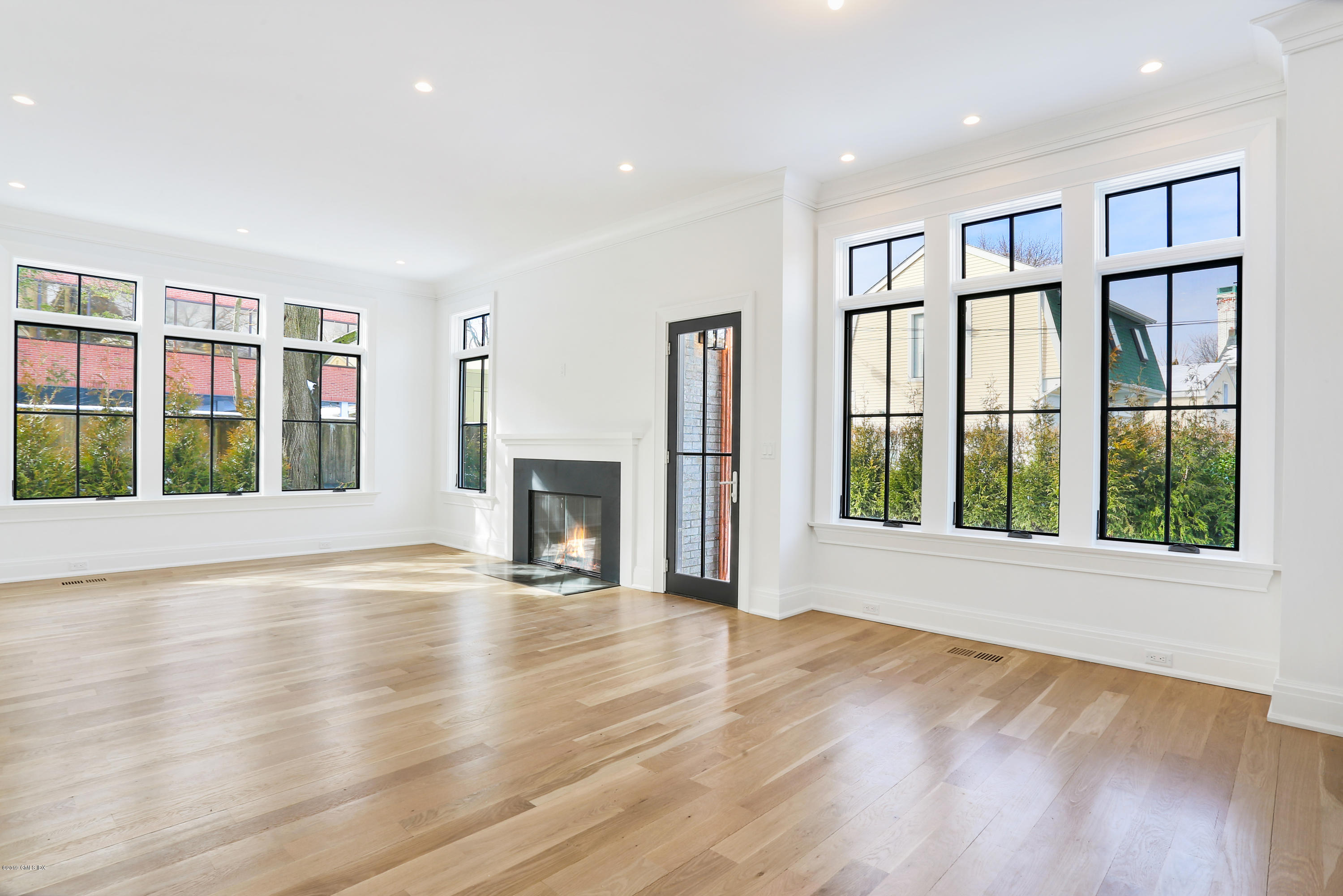 59 East Elm Street, Unit BACK Greenwich, CT 06830 - Photo 7 of 18 a view of an empty room with wooden floor and a window