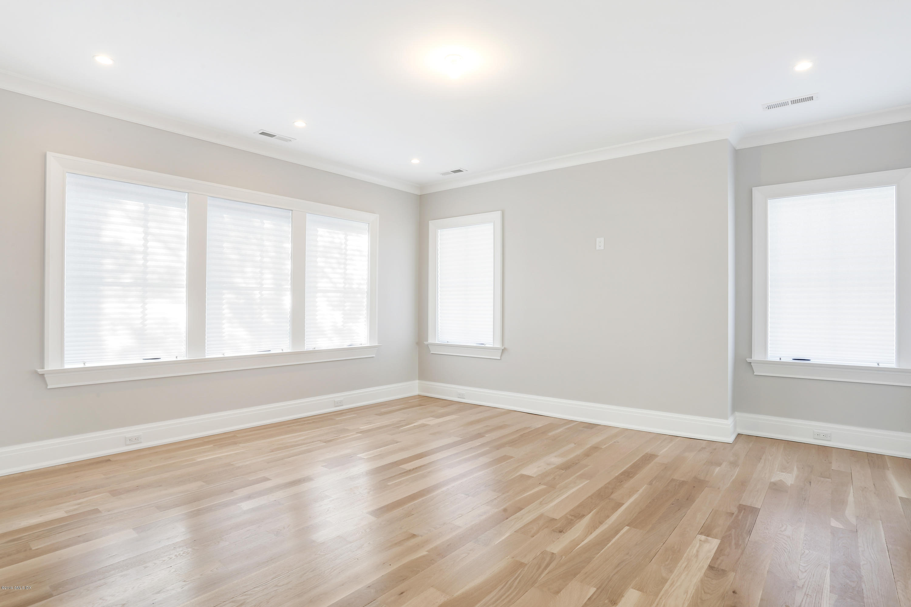 59 East Elm Street, Unit BACK Greenwich, CT 06830 - Photo 10 of 18 an empty room with wooden floor and windows