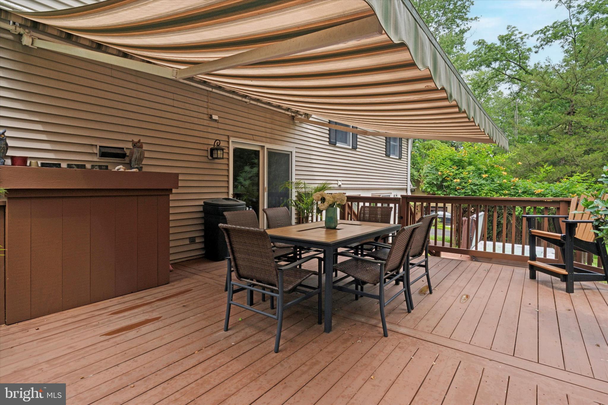 73 Tower Hill Road Doylestown, PA 18901 - Photo 54 of 76 a view of a roof deck with table and chairs floor to ceiling window with wooden floor