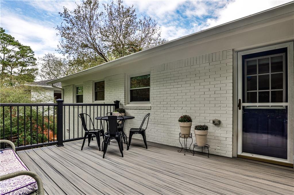 1010 Greenbriar Circle Decatur, GA 30033 - Photo 16 of 28 a view of a deck with table and chairs and wooden floor