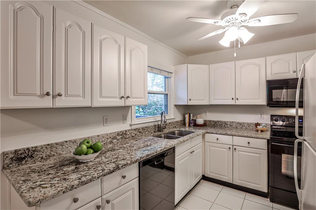 1010 Greenbriar Circle Decatur, GA 30033 - Photo 10 of 28 a kitchen with stainless steel appliances granite countertop a sink a stove and cabinets