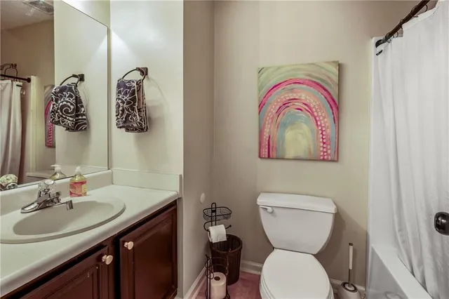 a bathroom with a toilet a sink and a mirror